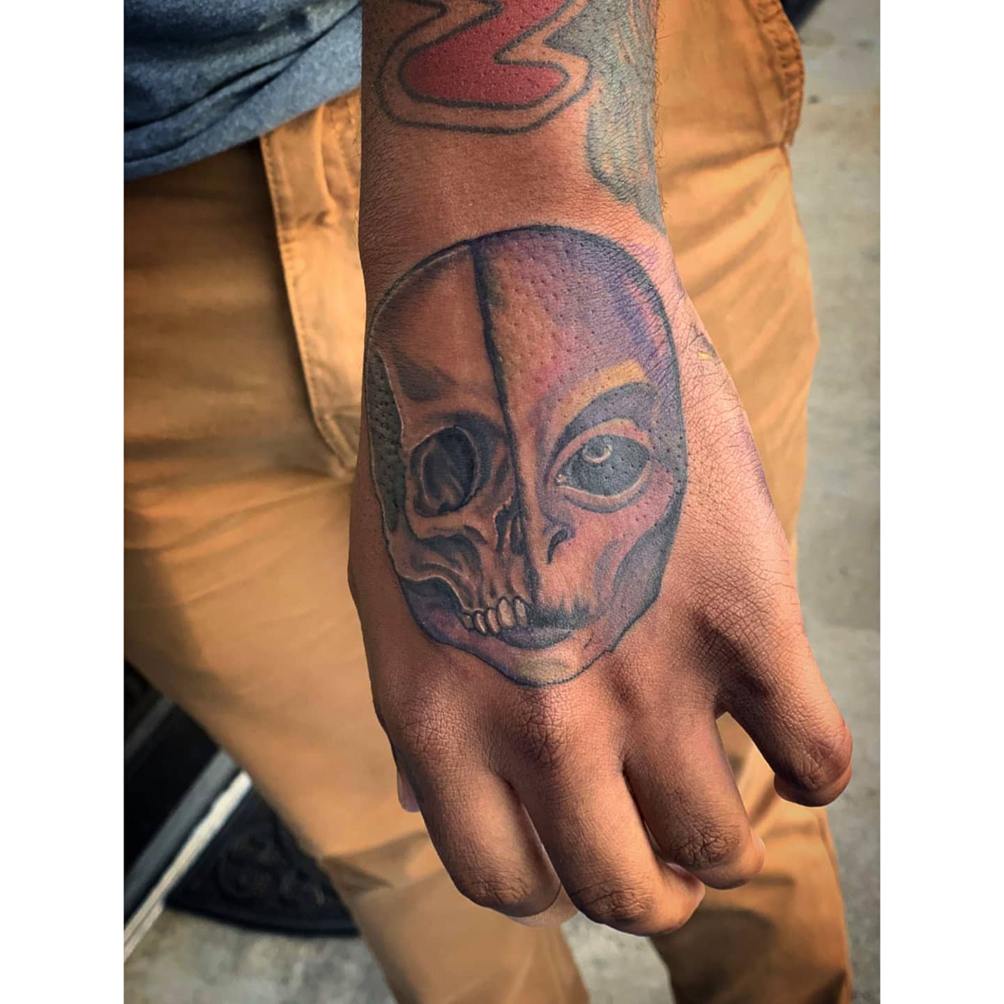 Skull realism tattoo on the hand by Tyler Cromwell