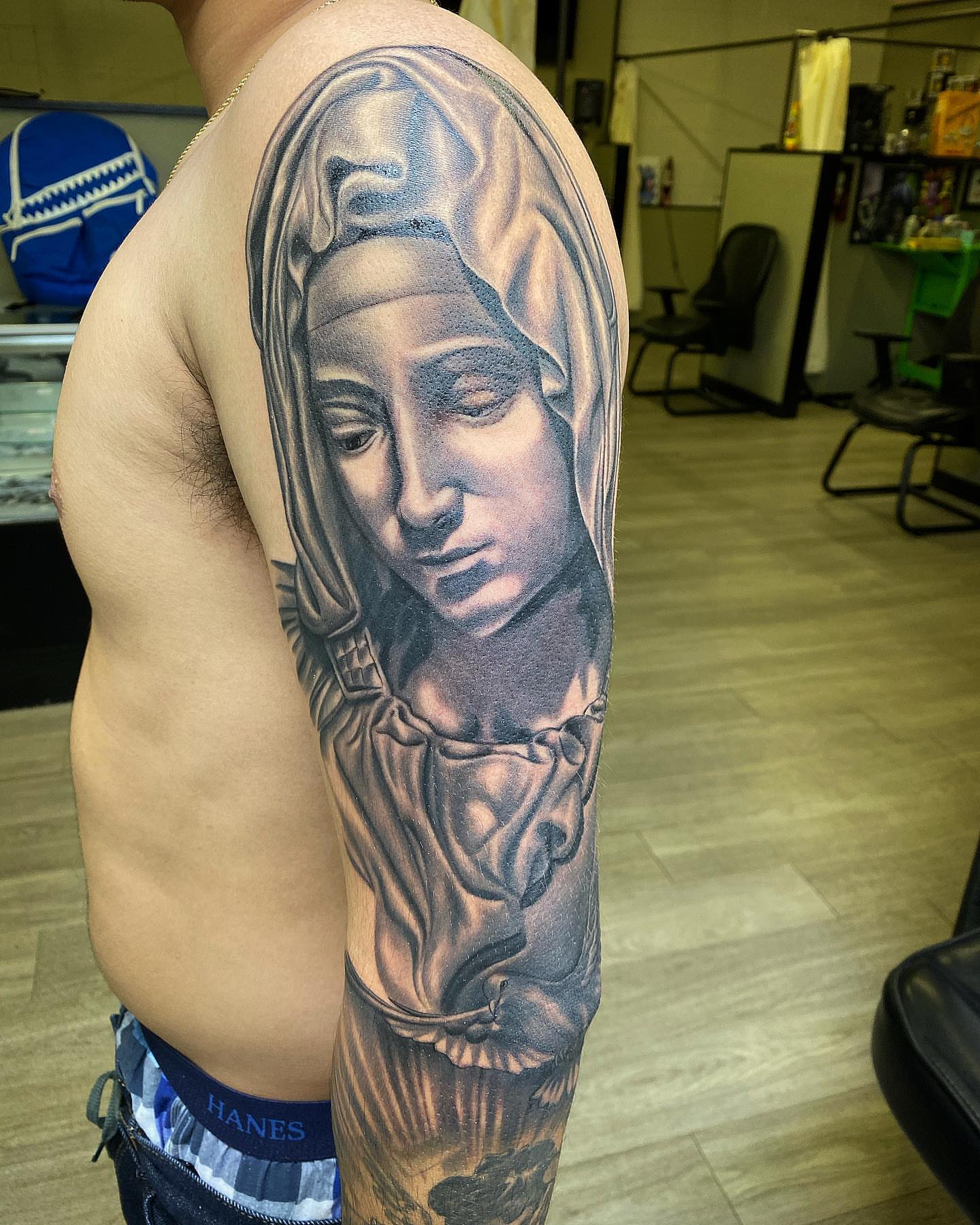 Religious figure realism tattoo on the upper arm by TattsByShorty