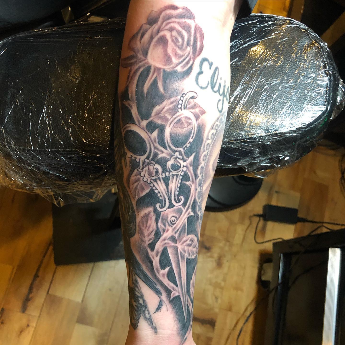 Rose and skull realism tattoo on the forearm by A.W.