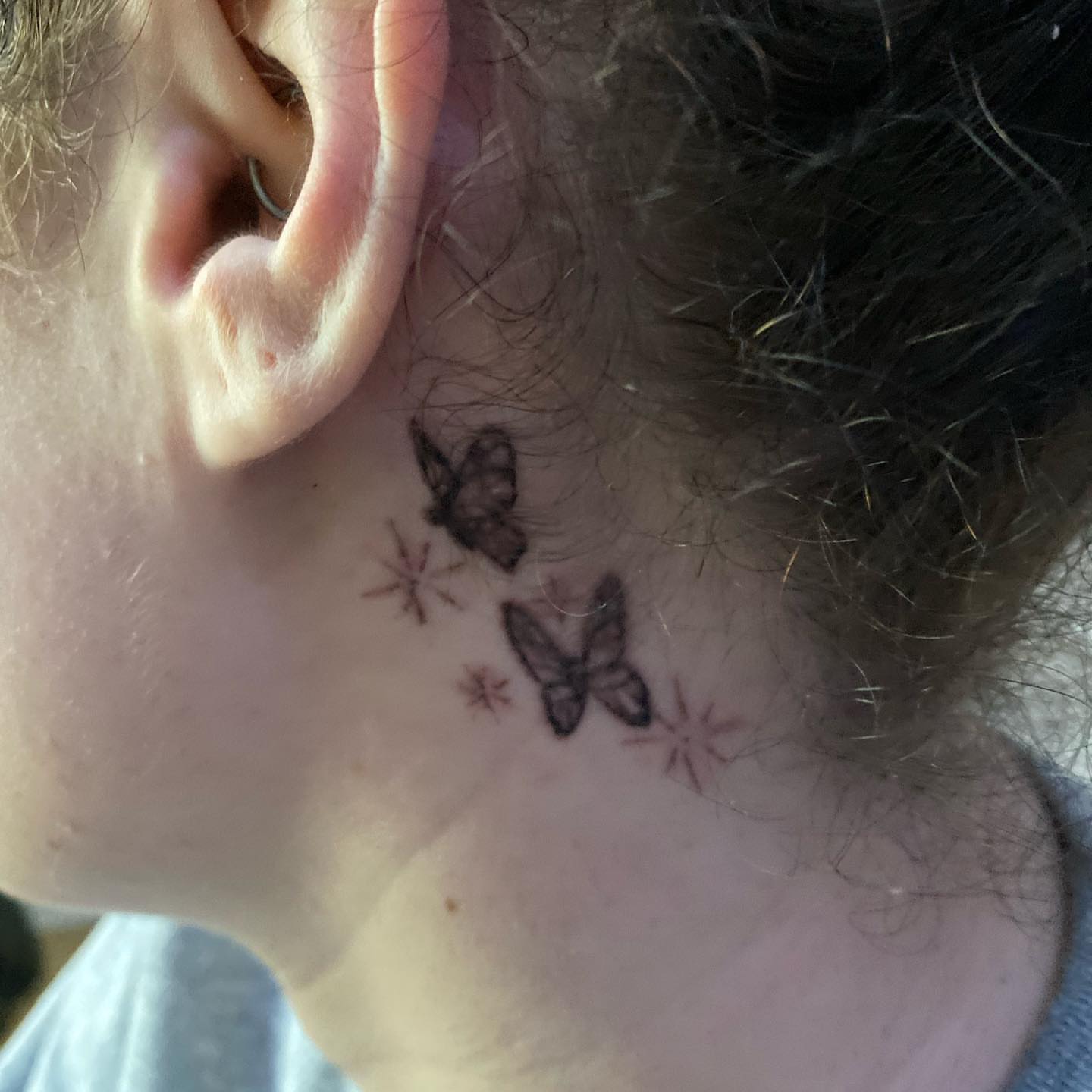 Butterflies dotwork tattoo on the neck by Daniel Monyongo
