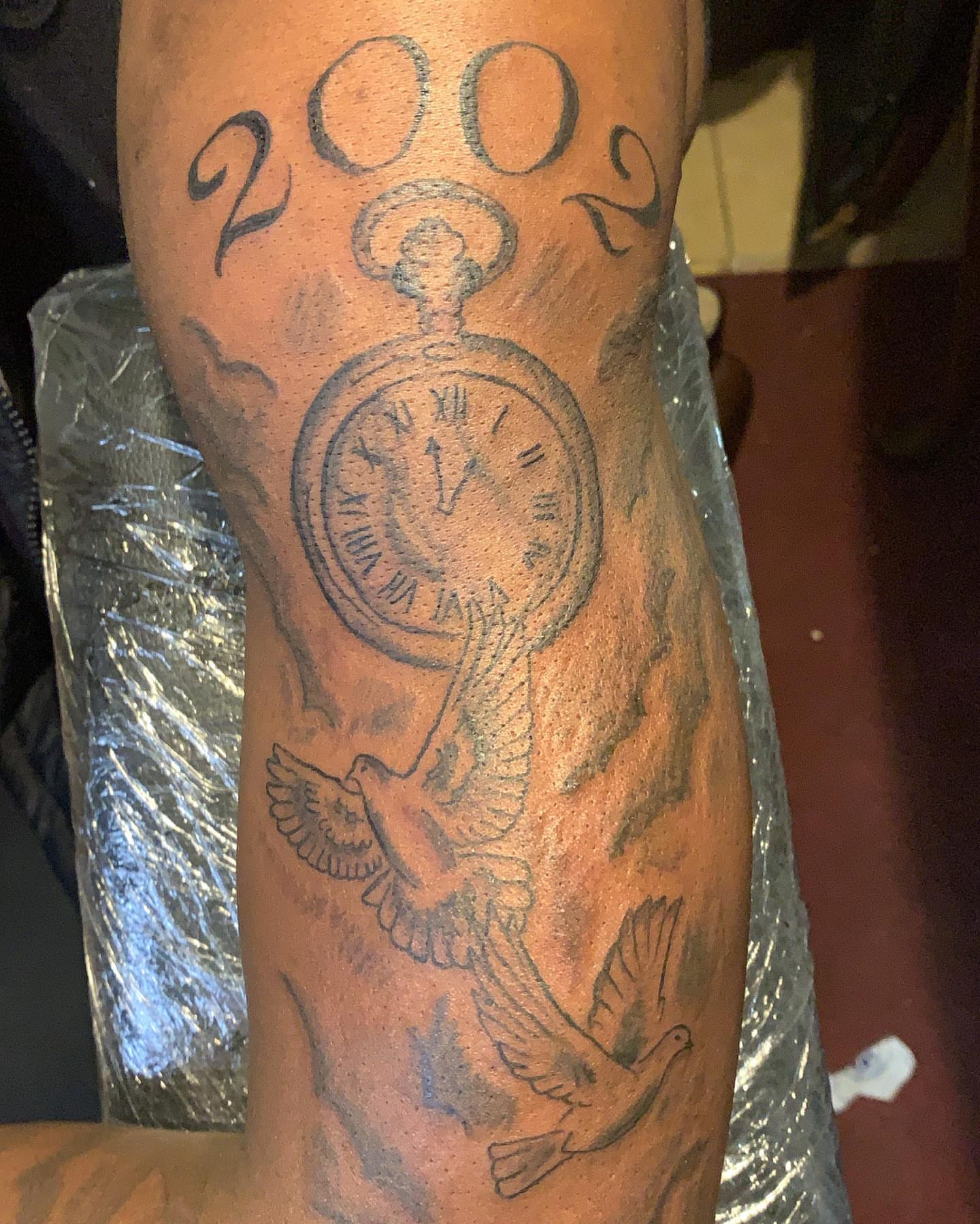 Clock and doves black and grey tattoo on the forearm by groovyyinkss