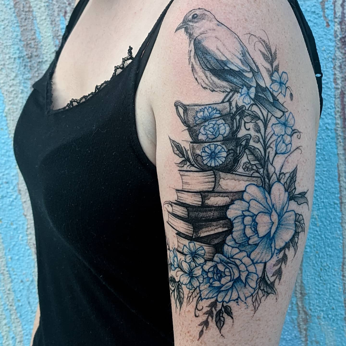 Bird and floral arrangement realism tattoo on the upper arm by Gail Howard Perry III