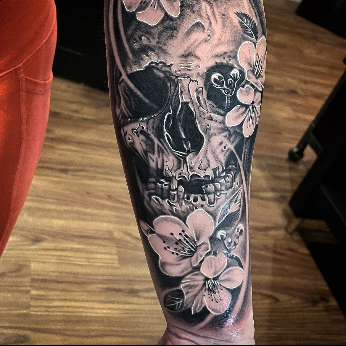 Skull and cherry blossoms realism tattoo on the forearm by Elijah Forster - Nashville Tattoo Artist