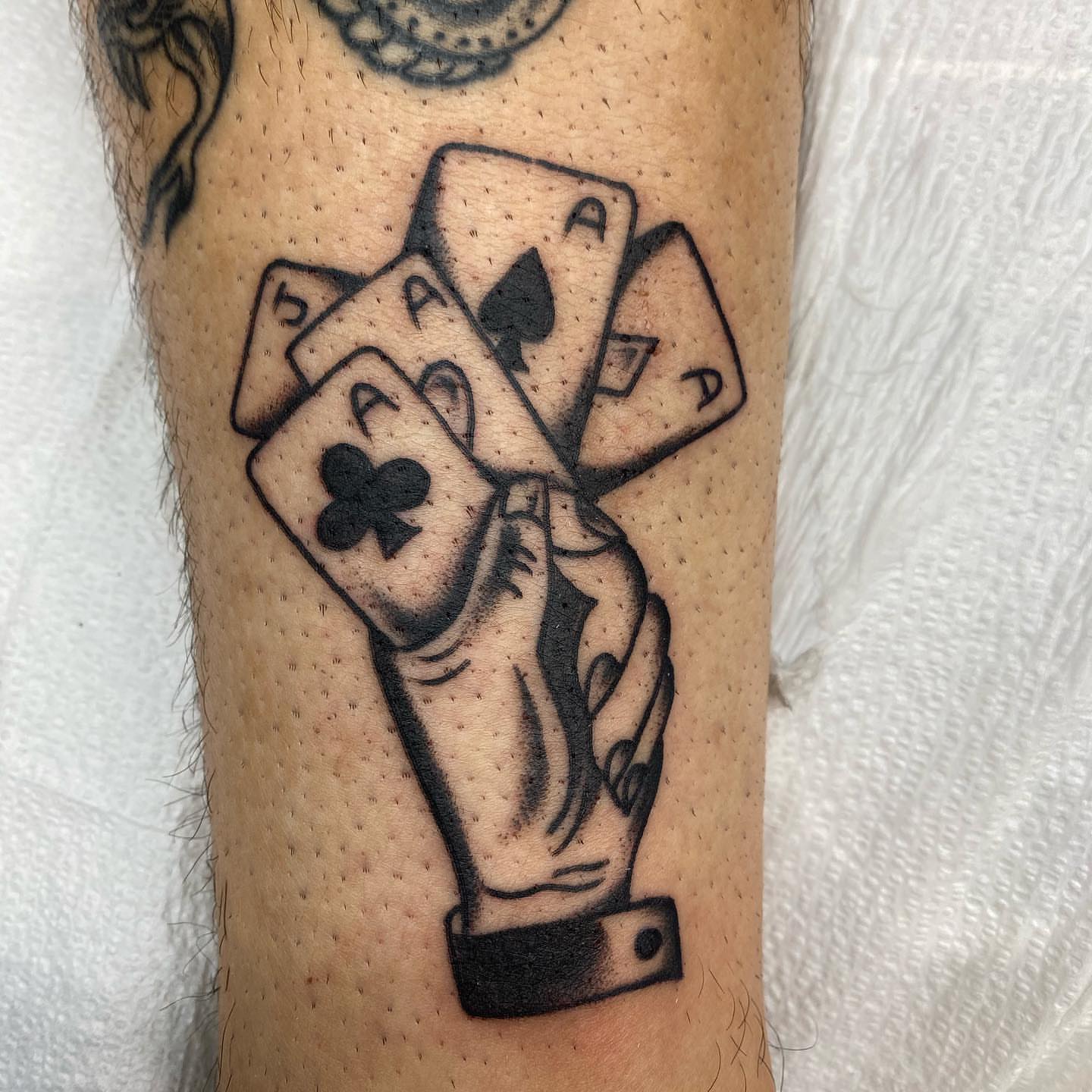 Playing cards black and grey tattoo on the forearm by Dave G