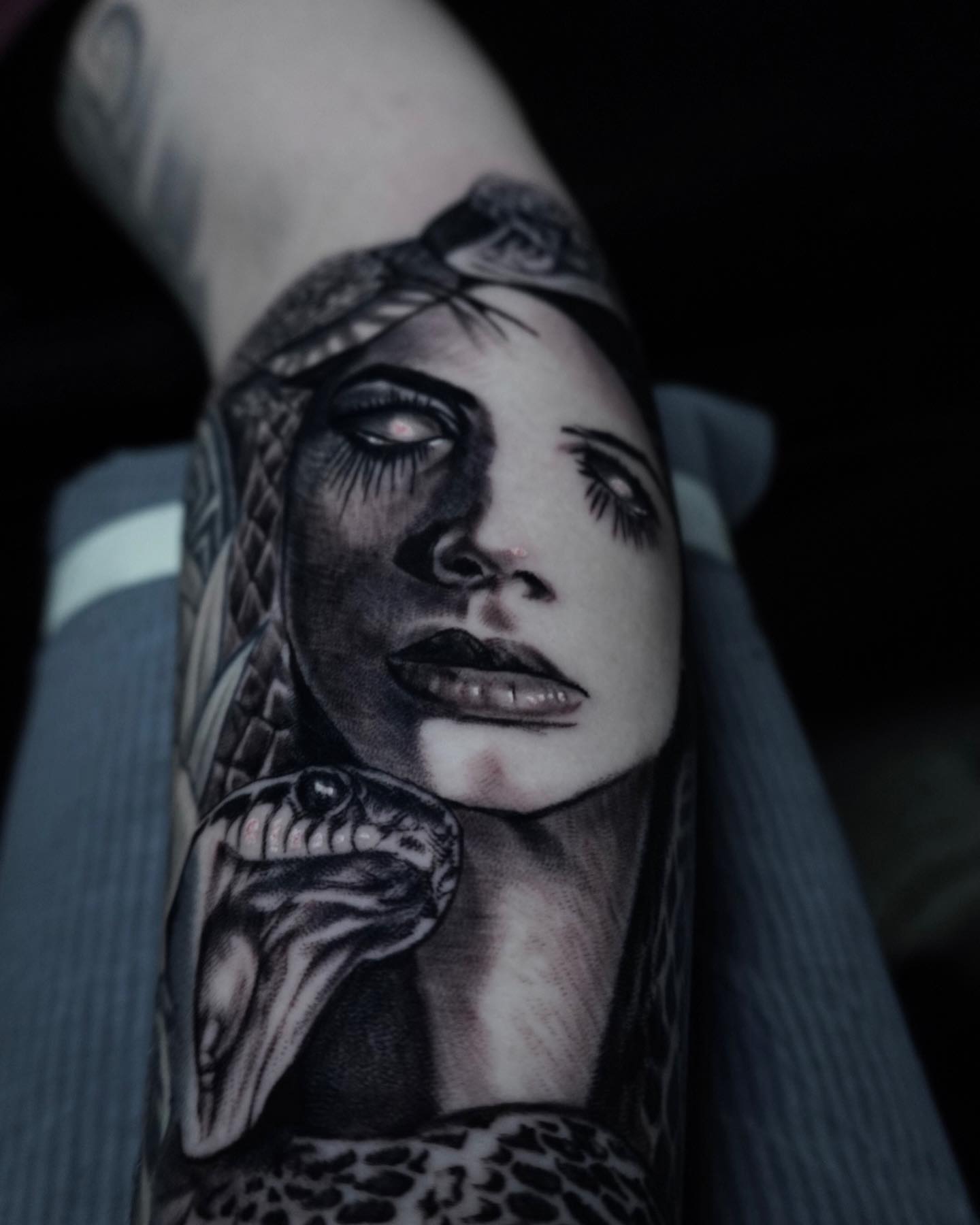 Woman with snake realism tattoo on the forearm by Brian Cassidy