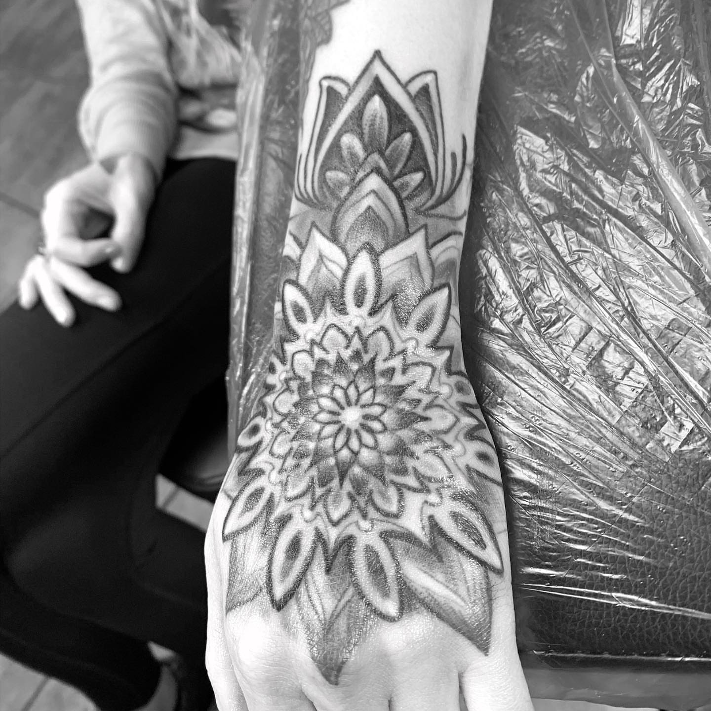 Lotus flower geometric tattoo on the forearm by Phil Robertson