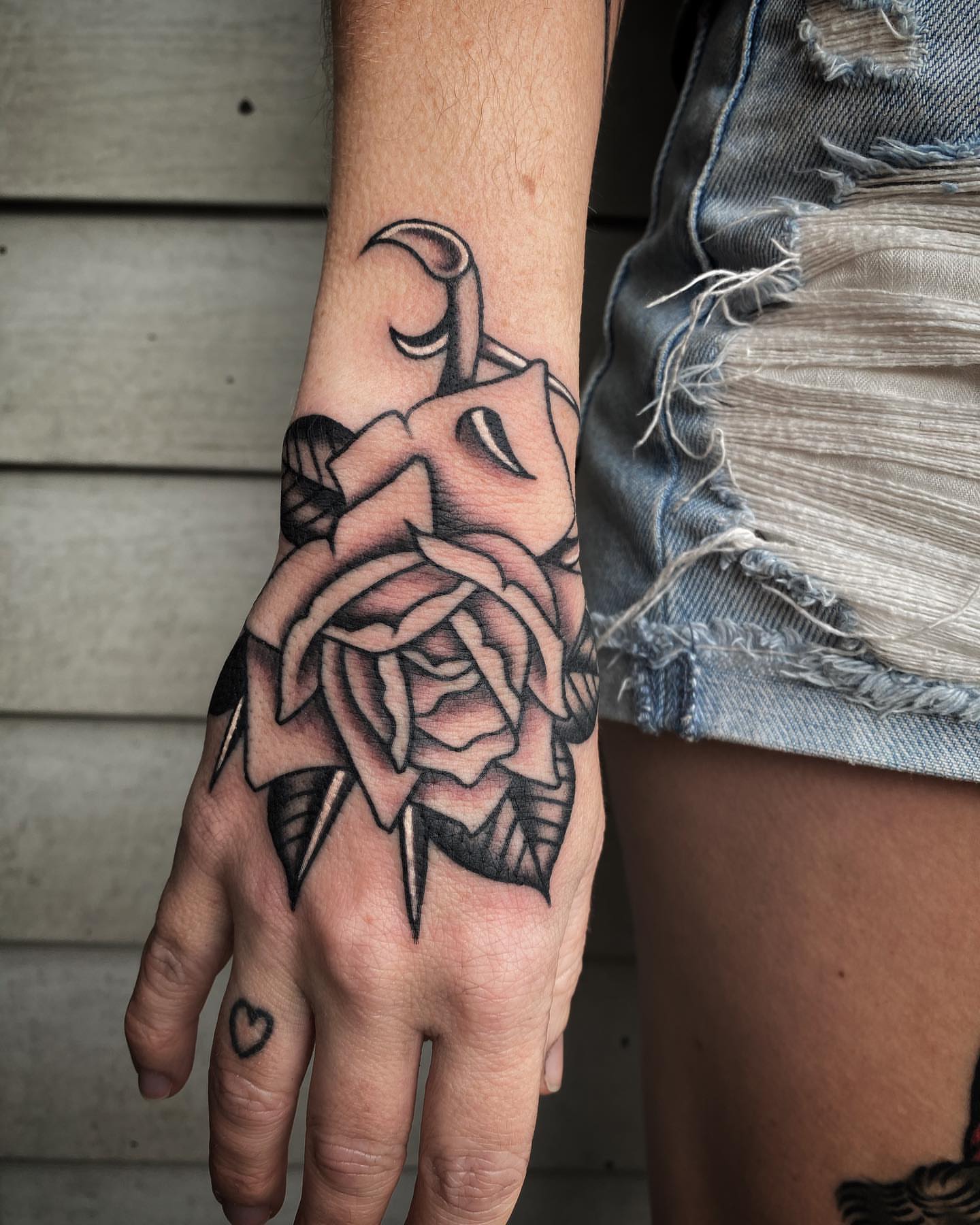 Rose black and grey tattoo on the hand by Daniel Mesen