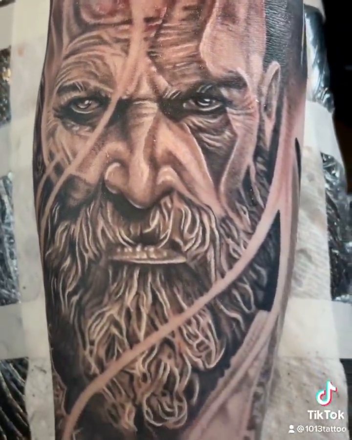 Kratos portrait with Omega symbol realism tattoo by Elijah Forster - Nashville Tattoo Artist