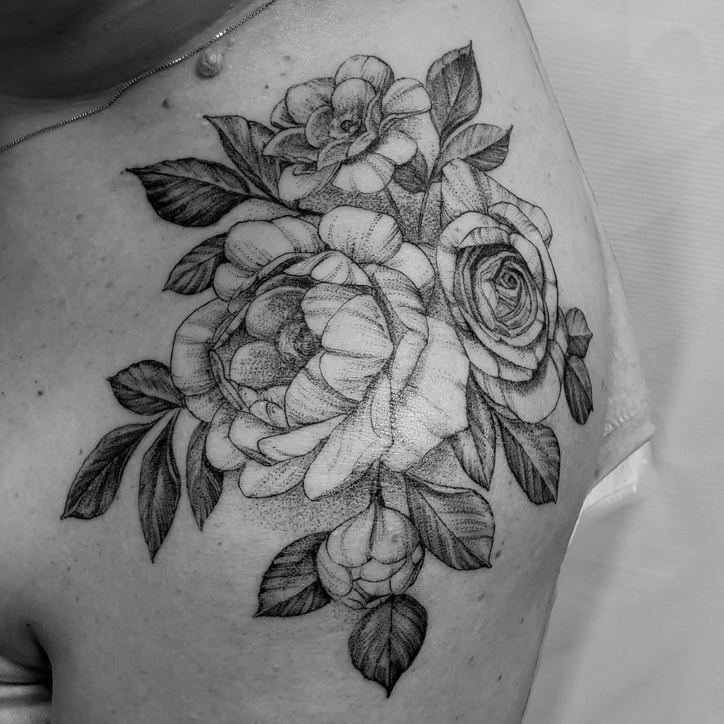 Flowers dotwork tattoo on the shoulder by Matthew Barnett