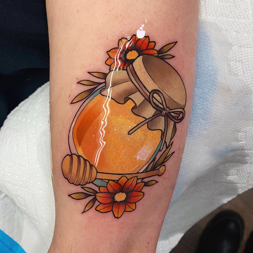 Honey jar and flowers new school tattoo on the forearm by Shelby Ouellette