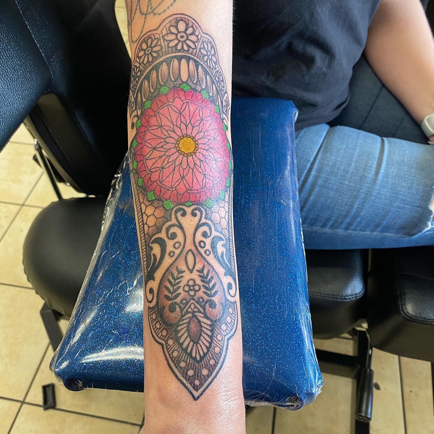 Floral mandala geometric tattoo on the forearm by Nicholas Jones