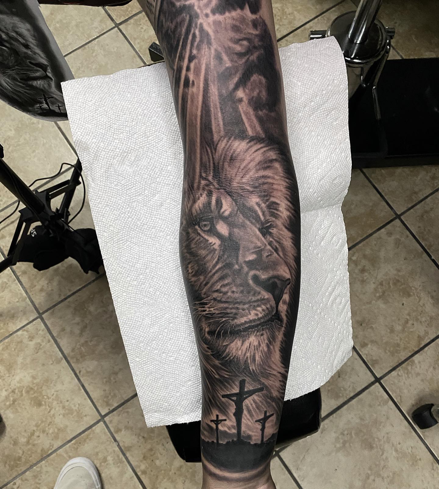 Lion realism tattoo on the forearm by Gary Graves