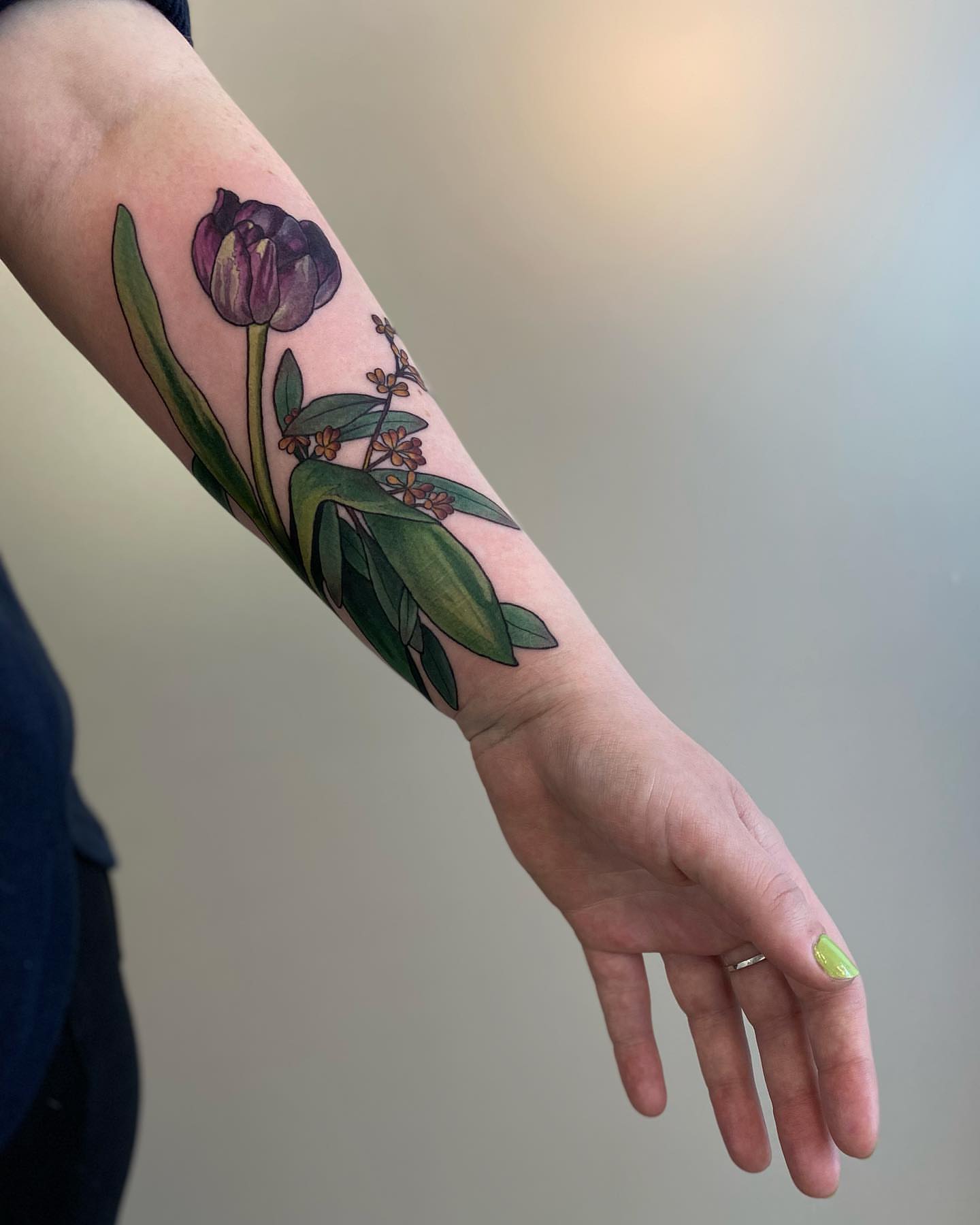 Tulip and leaves realism tattoo on the forearm by Rusty Indigo