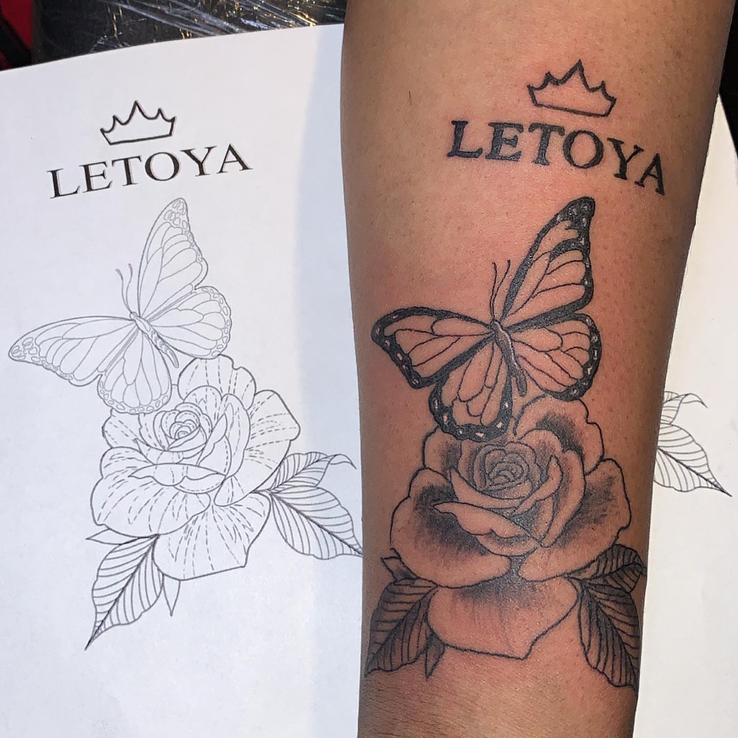 Butterfly and rose black and grey tattoo on the forearm by groovyyinkss