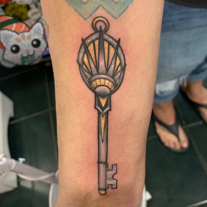 Key geometric tattoo on the forearm by Cortney Norton
