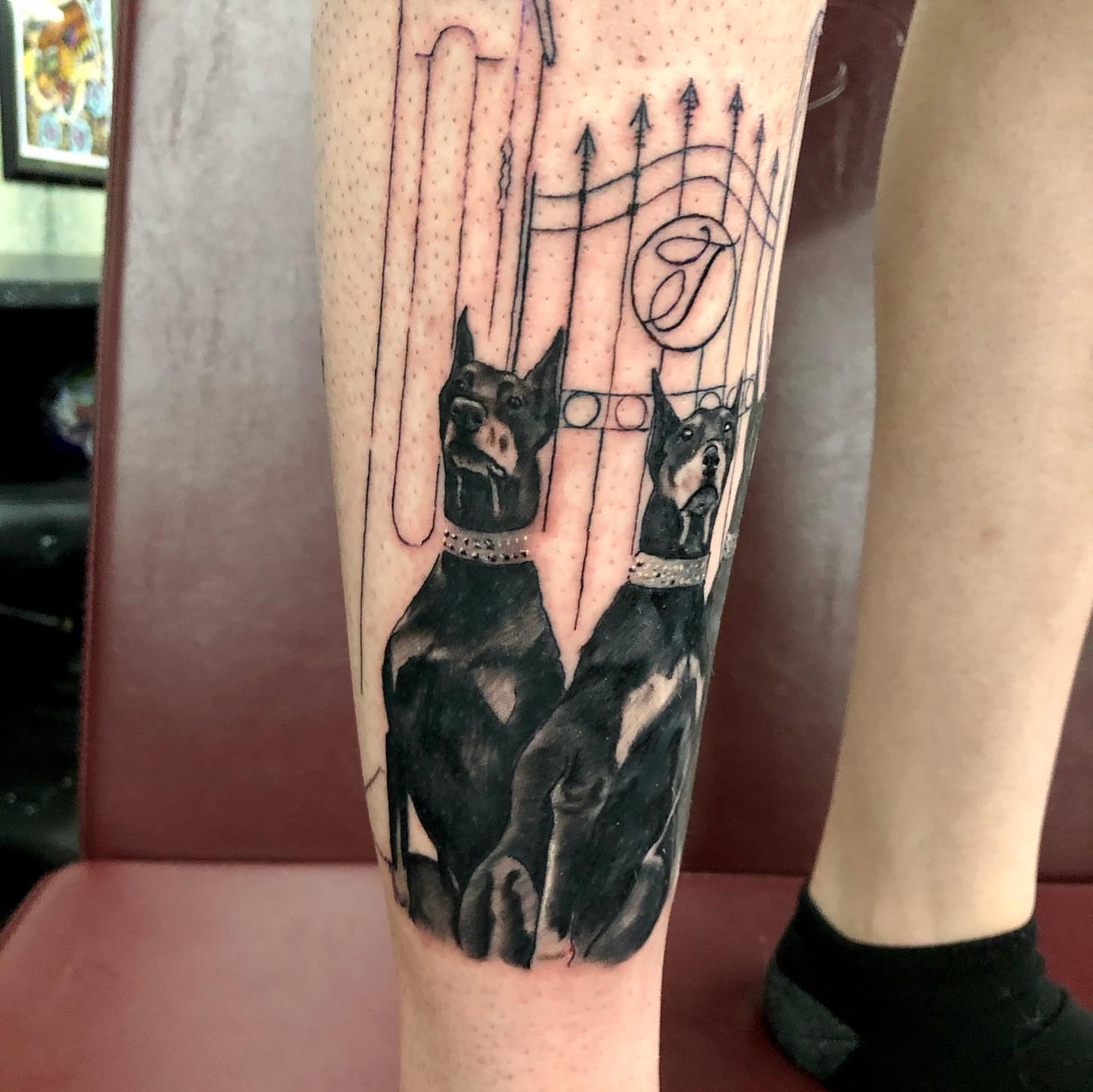 Doberman dogs realism tattoo on the forearm by Tattoos by Rey G.