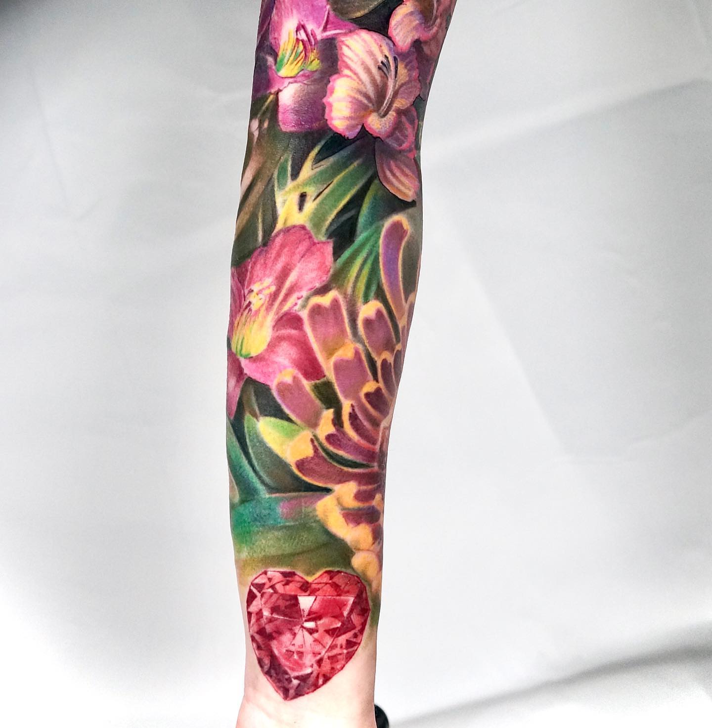 Floral bouquet with heart realism tattoo on the forearm by ๐ฝ๐๐๐๐๐๐๐ ๐ถ๐๐๐