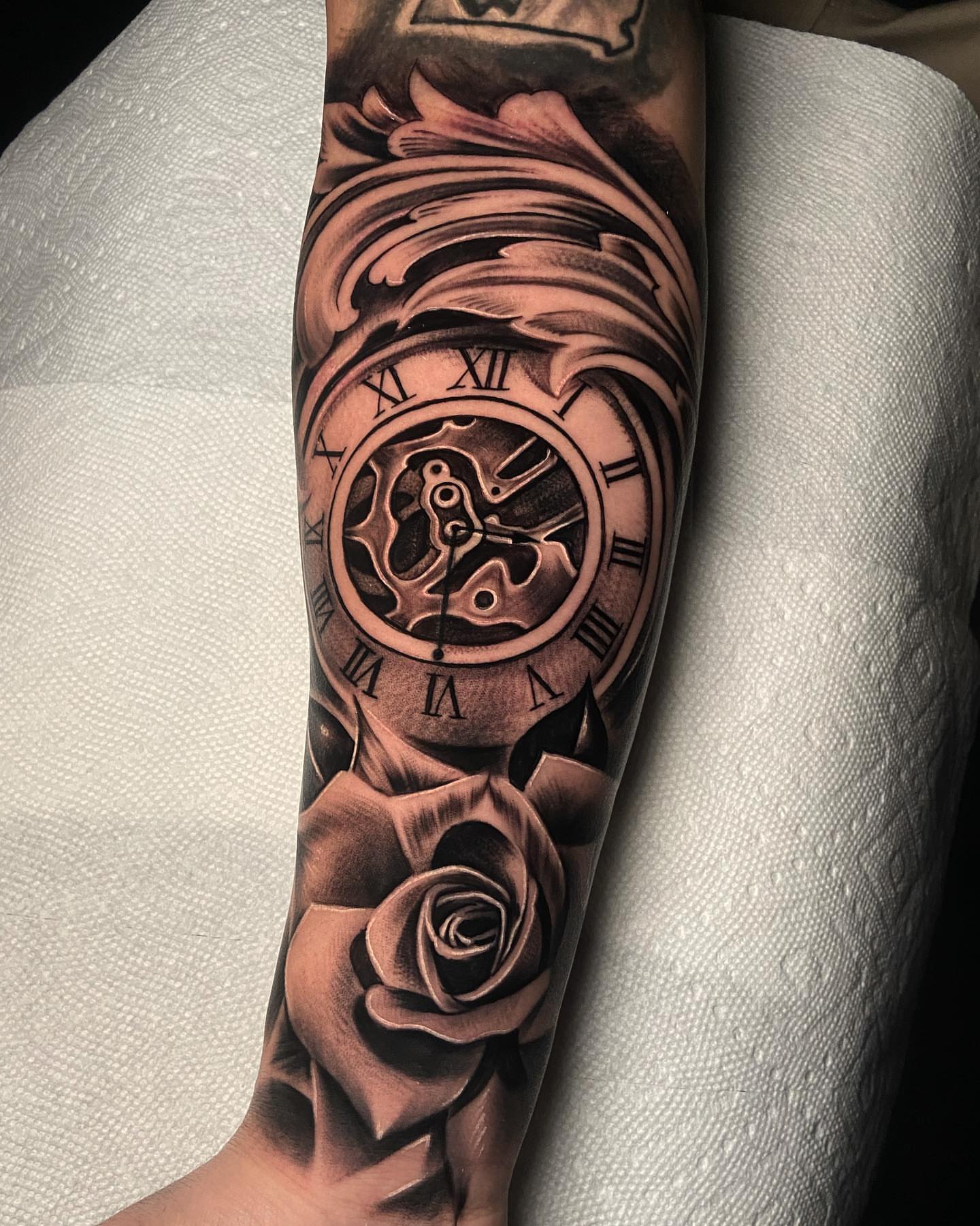 Clock and rose realism tattoo on the forearm by eksoe_