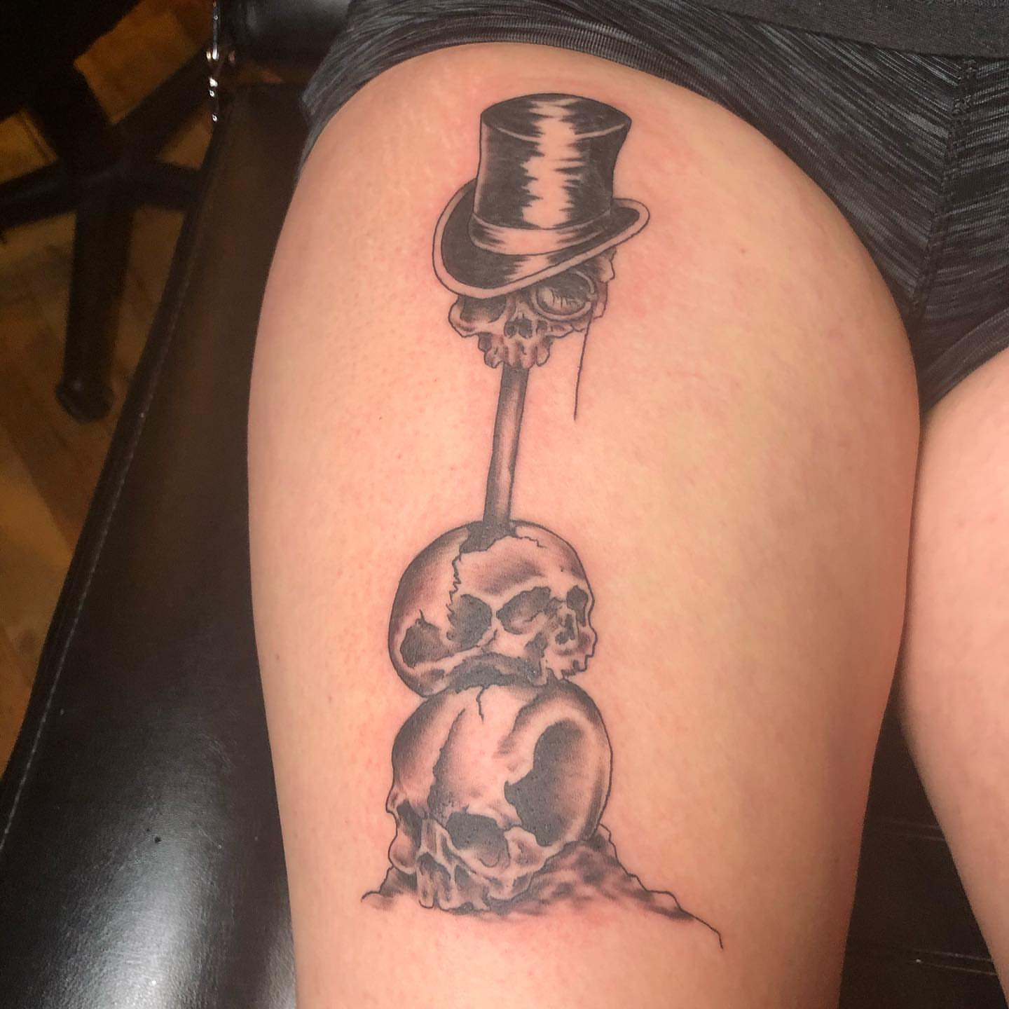 Skulls and top hat realism tattoo on the thigh by A.W.
