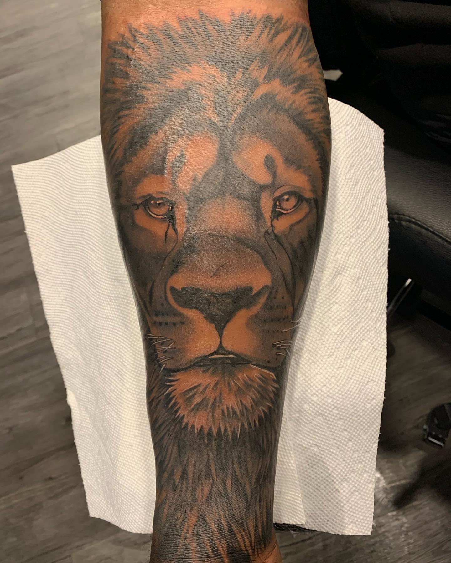 Lion realism tattoo on the forearm by ATLANTA Queer Tattooer