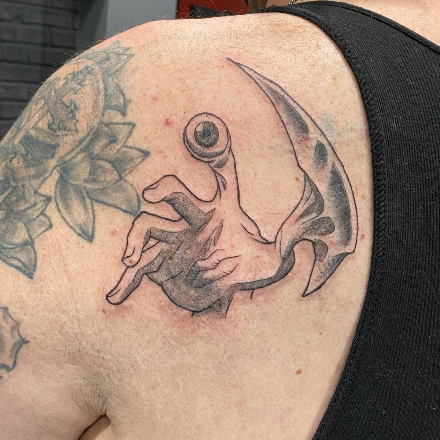 Eye and crescent moon black and grey tattoo on the shoulder by Zachary Kaufhold