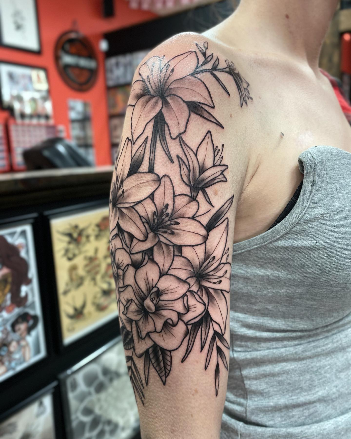 Lilies black and grey tattoo on the upper arm by Jake Snoddy, Franklin, Tennessee