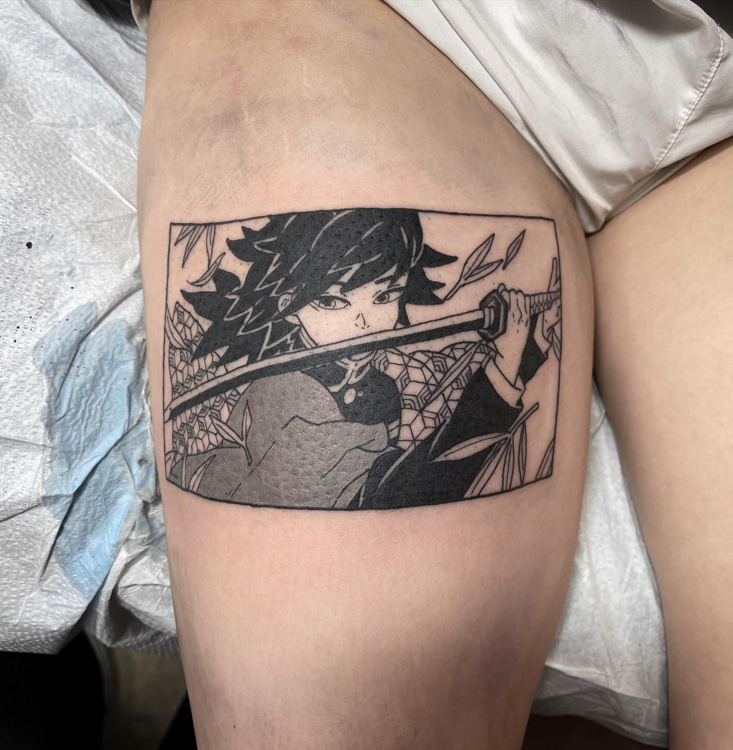 Anime character with sword anime tattoo on the thigh by Jake Snoddy, Franklin, Tennessee