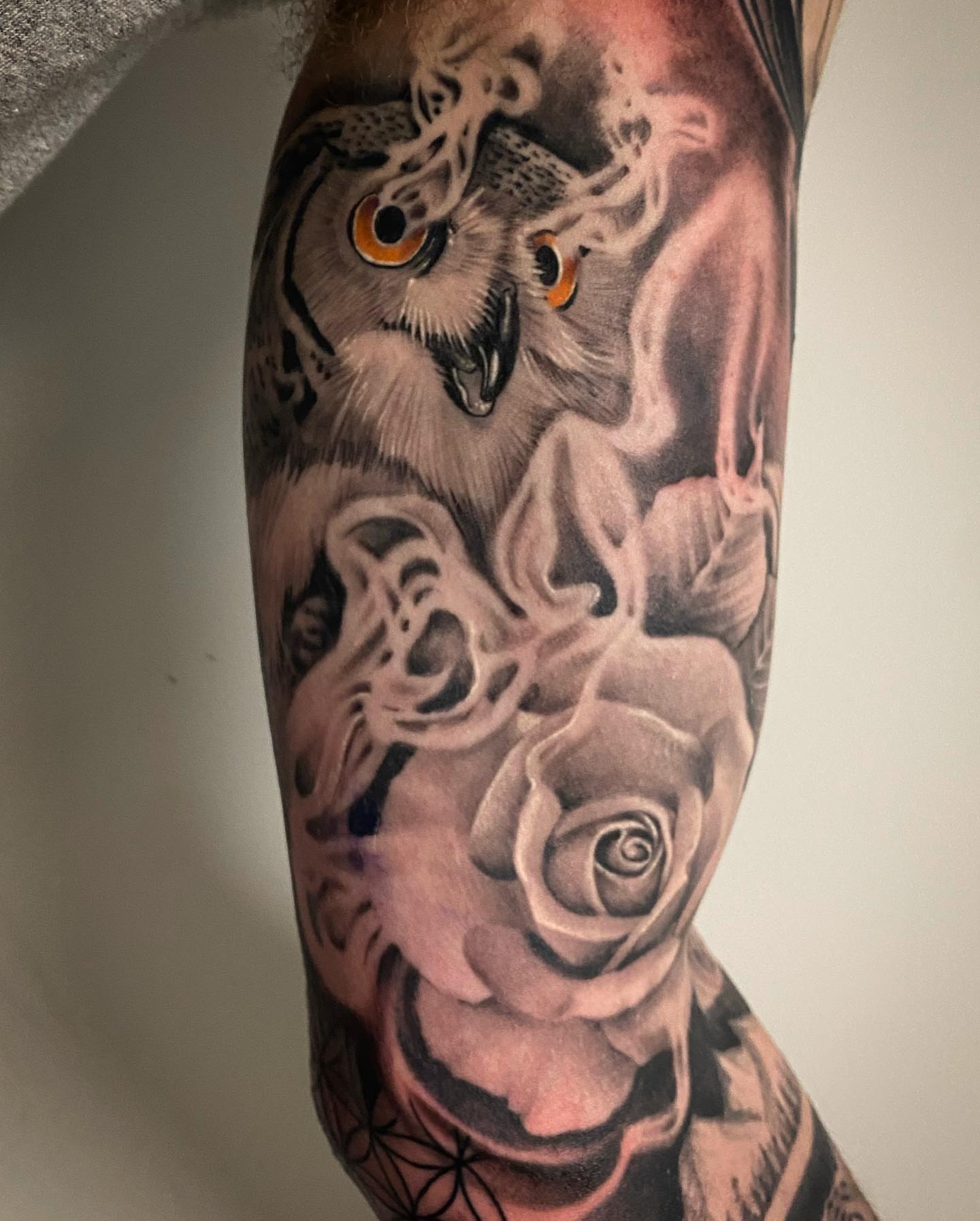 Owl and roses realism tattoo on the forearm by Dale DeVille