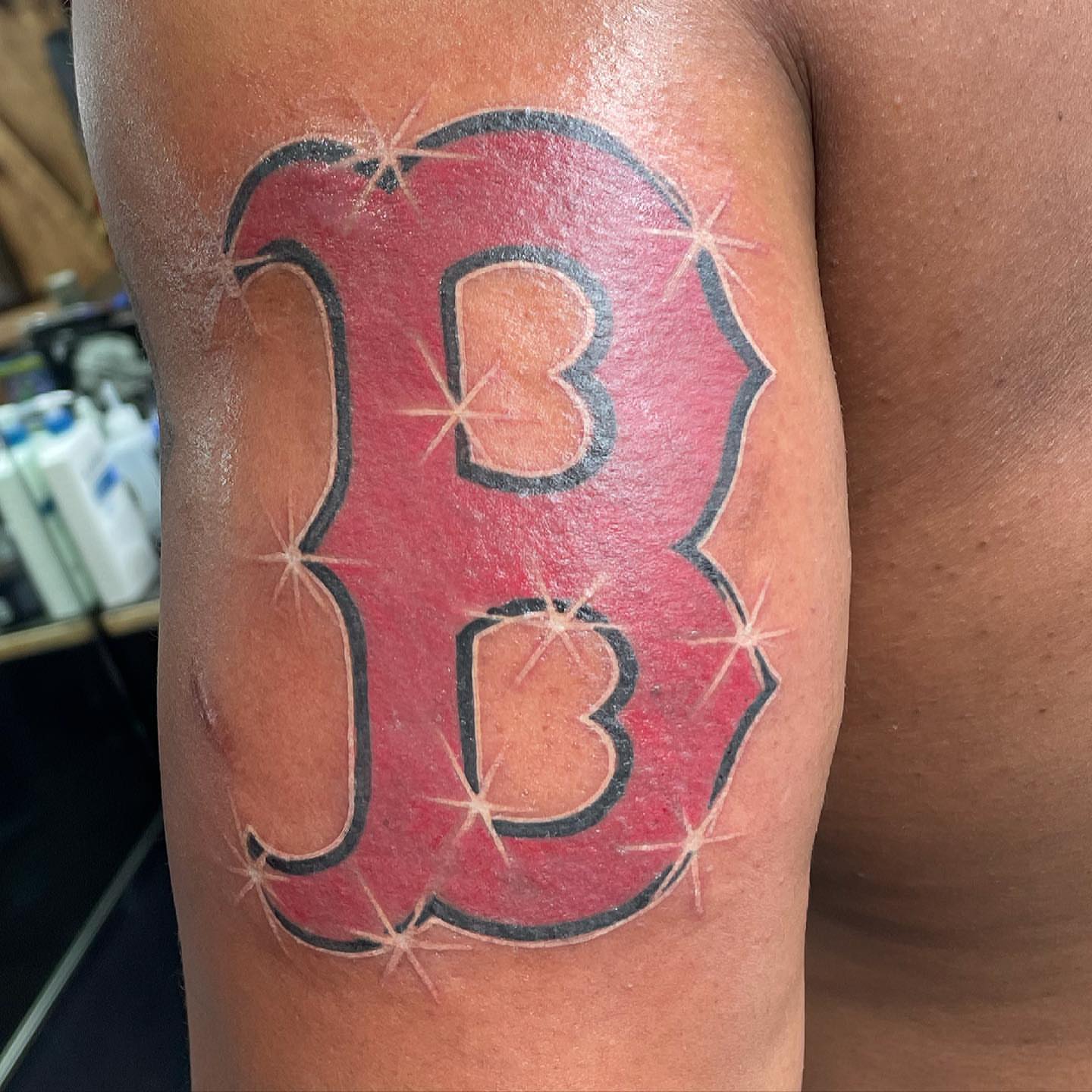 Red letter B American traditional tattoo on the forearm by Yari, Los Angeles, California