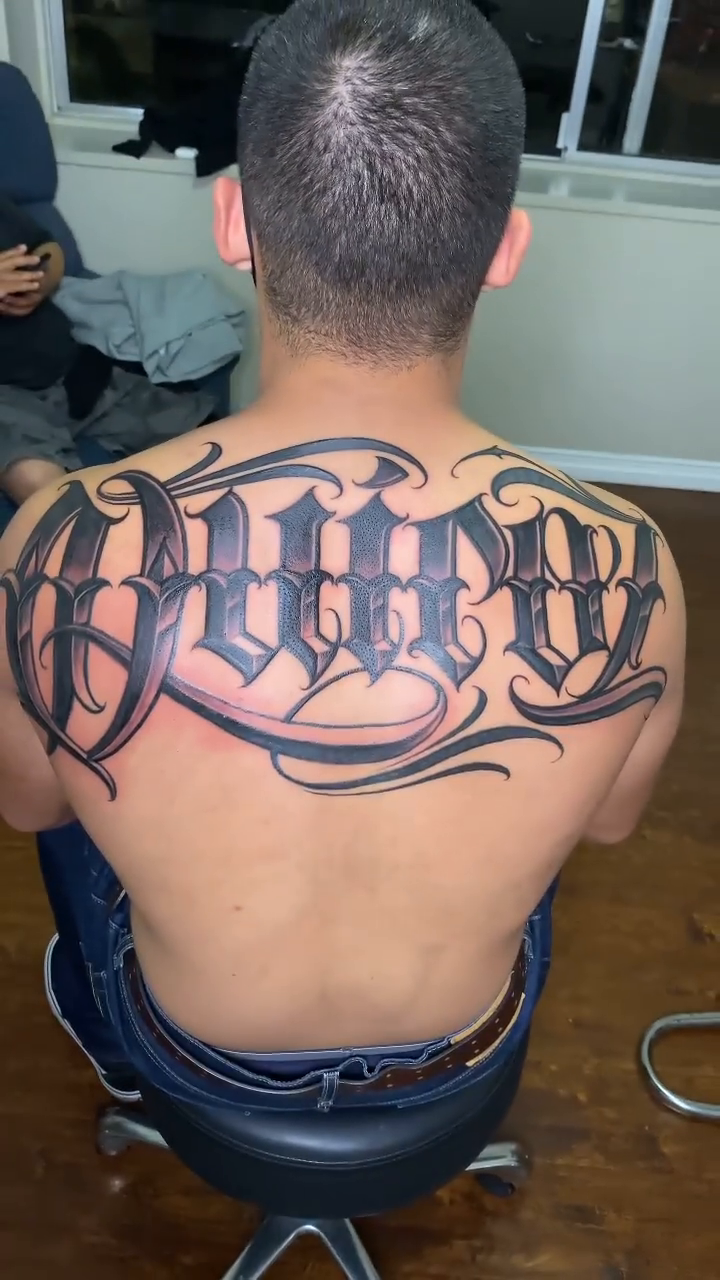 Tattoo by @smileys_ink — lettering_script, chicano