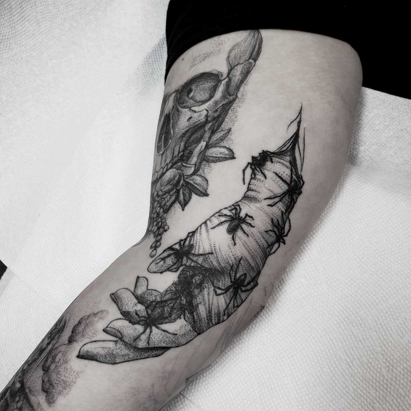 Skull and floral dotwork tattoo on the forearm by Matthew Barnett