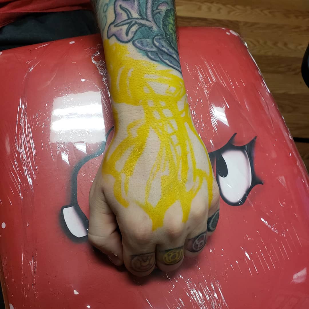 Yellow flame new school tattoo on the hand by Don Taylor