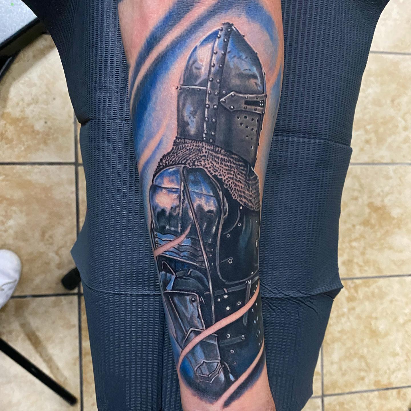 Knight helmet realism tattoo on the forearm by Gary Graves