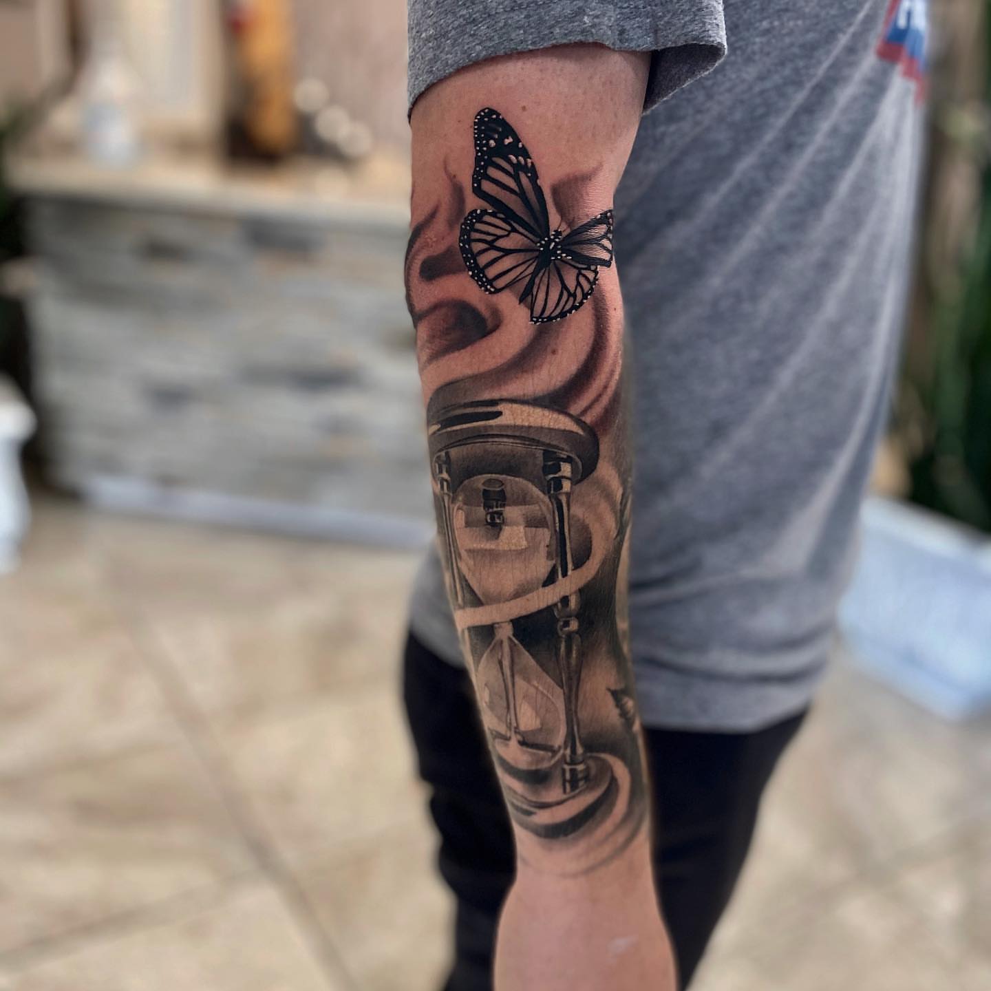 Hourglass and butterfly realism tattoo on the forearm by Aaron Carey, Salem, Oregon