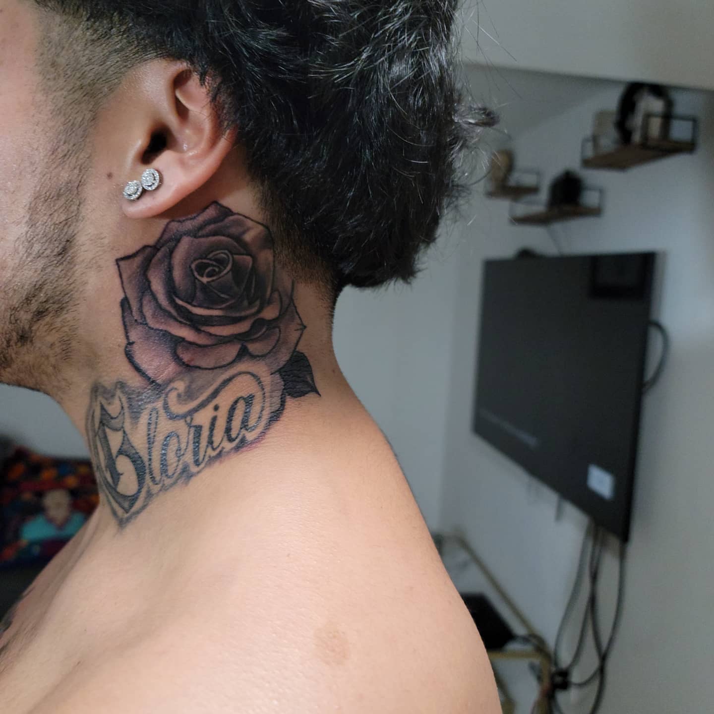 Rose and script black and grey tattoo on the neck by Eddy
