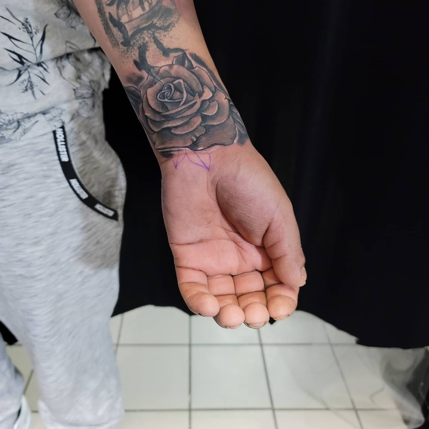 Rose black and grey tattoo on the forearm by Eddy
