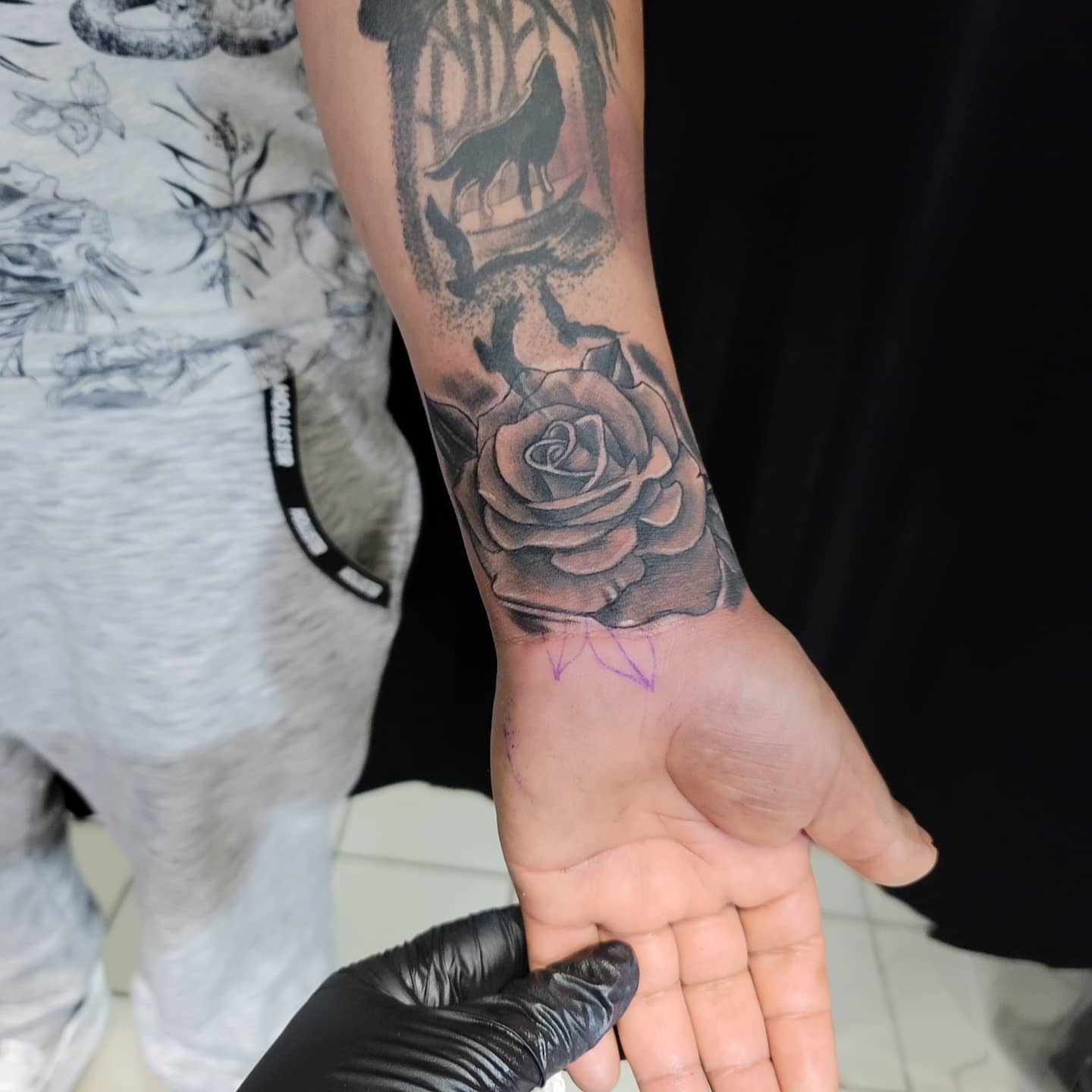 Rose and wolf realism tattoo on the forearm by Eddy