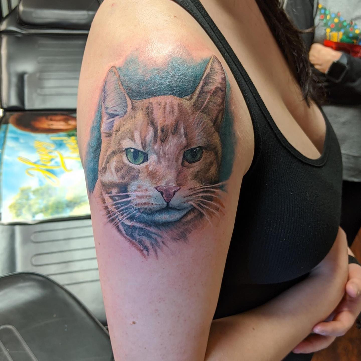Cat realism tattoo on the upper arm by Seth Scott