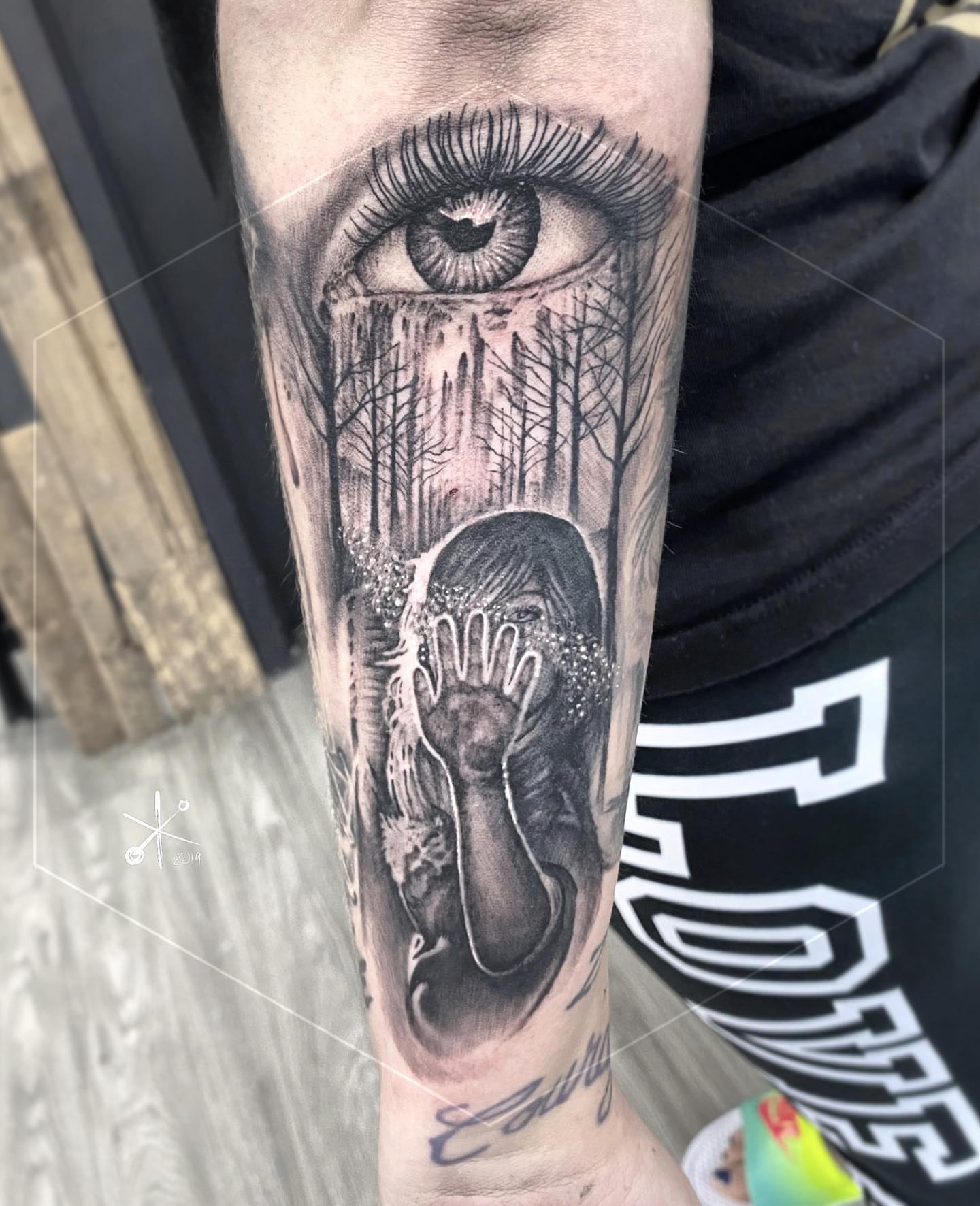 Eye and forest realism tattoo on the forearm by Jax Citriglia