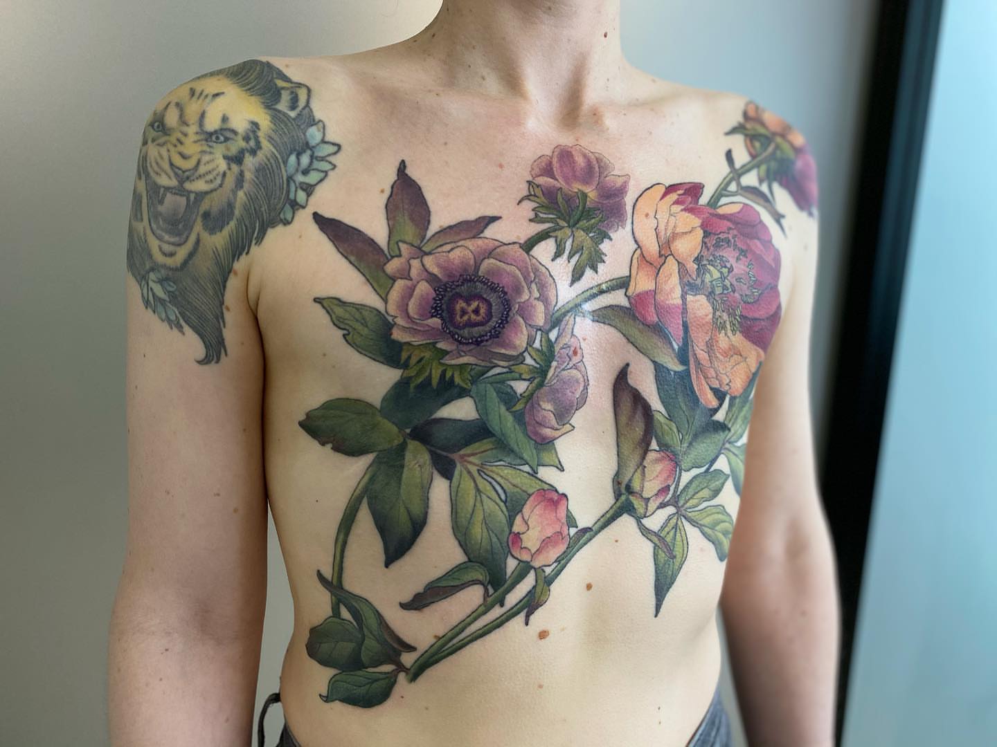 Floral arrangement realism tattoo on the chest by Rusty Indigo