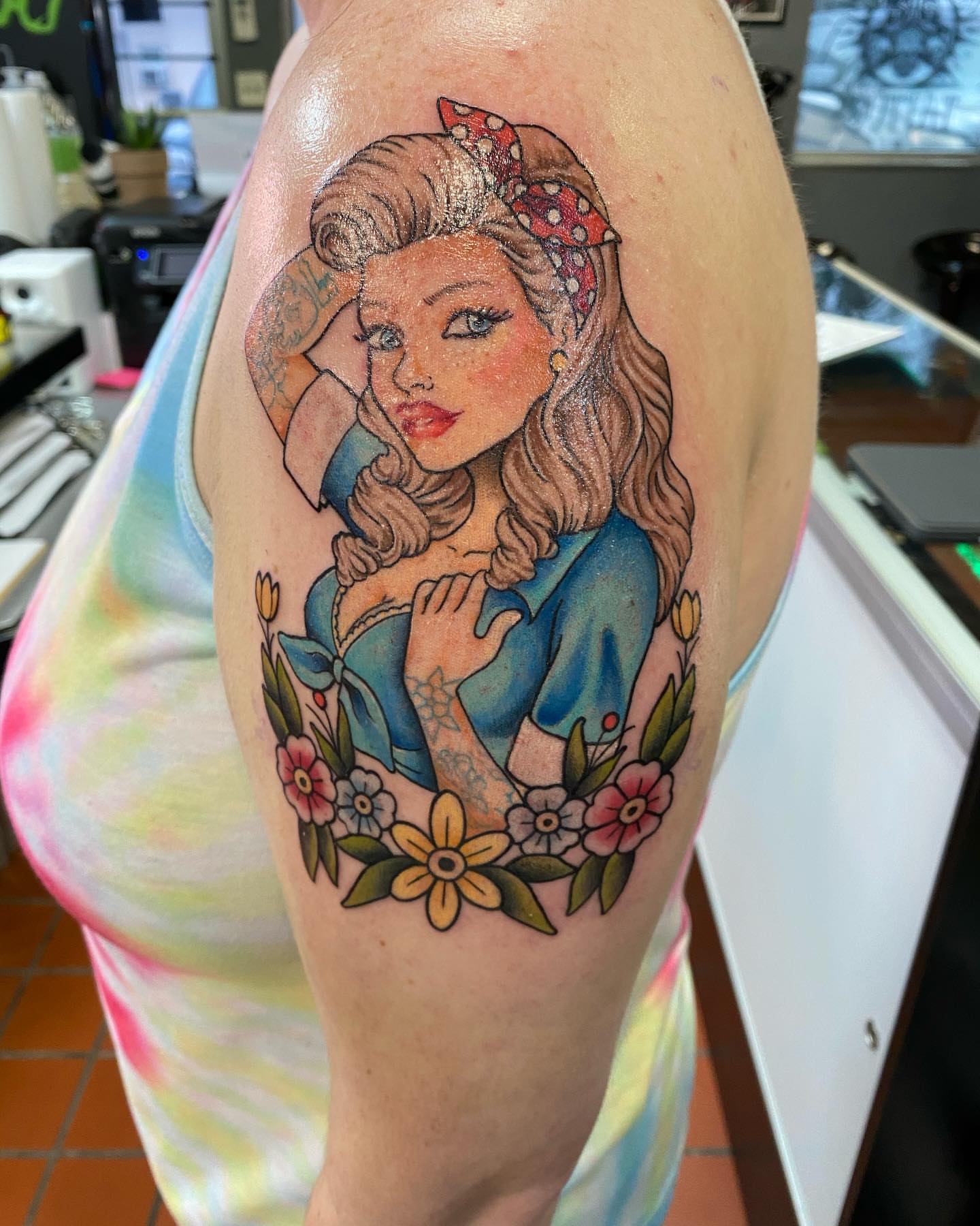 Woman with flowers American traditional tattoo on the upper arm by Valen Laska