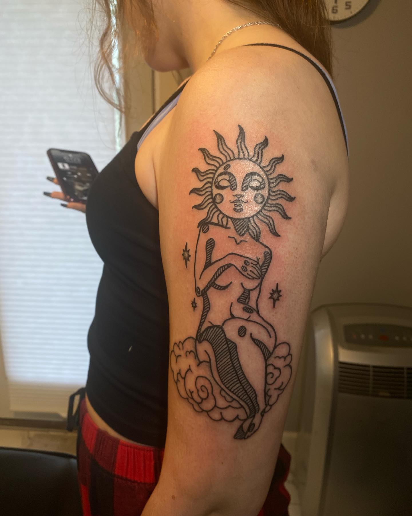 Sun and mermaid black and grey tattoo on the upper arm by Desirae✨