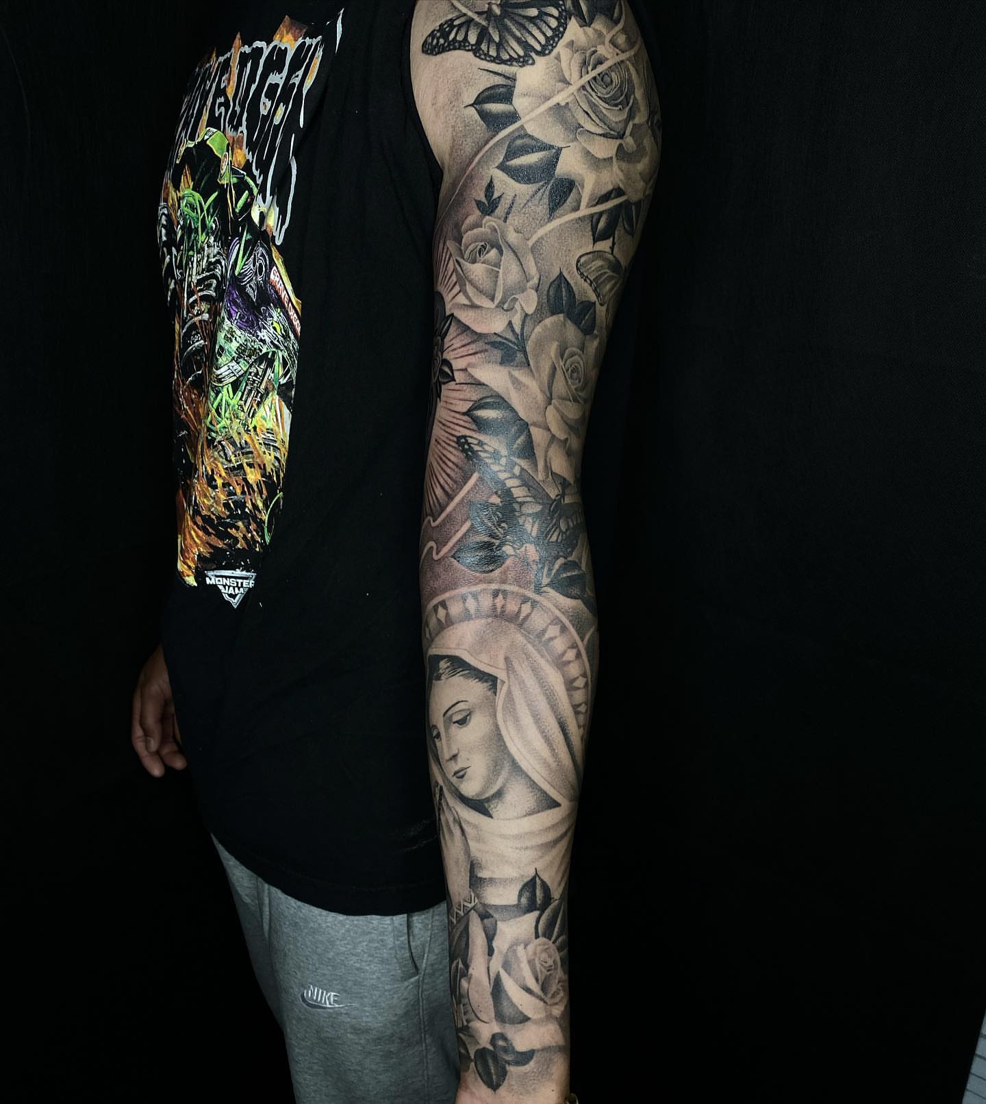 Religious figure with roses realism tattoo on the forearm by DH Tattooing