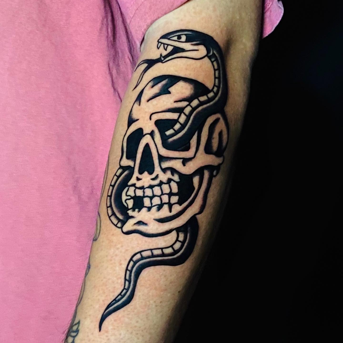 Skull and snake black and grey tattoo on the forearm by David Mendieta