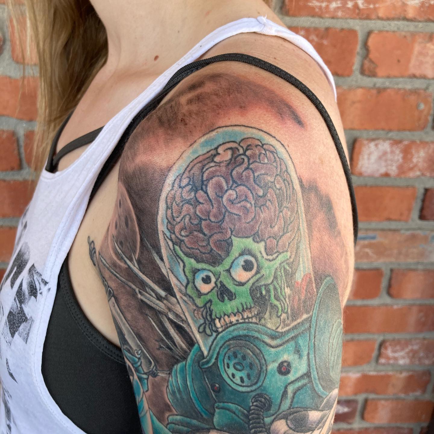 Cyborg skull with brain realism tattoo on the shoulder by Chuck House