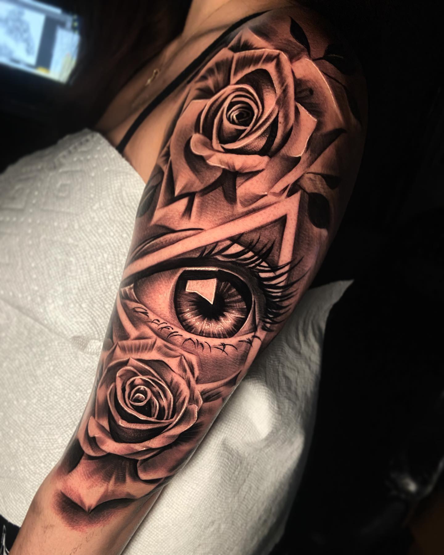 Eye and roses realism tattoo on the forearm by eksoe_