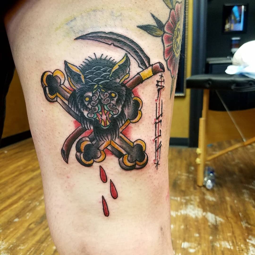 Skull and crossbones American traditional tattoo on the thigh by Rue McLean