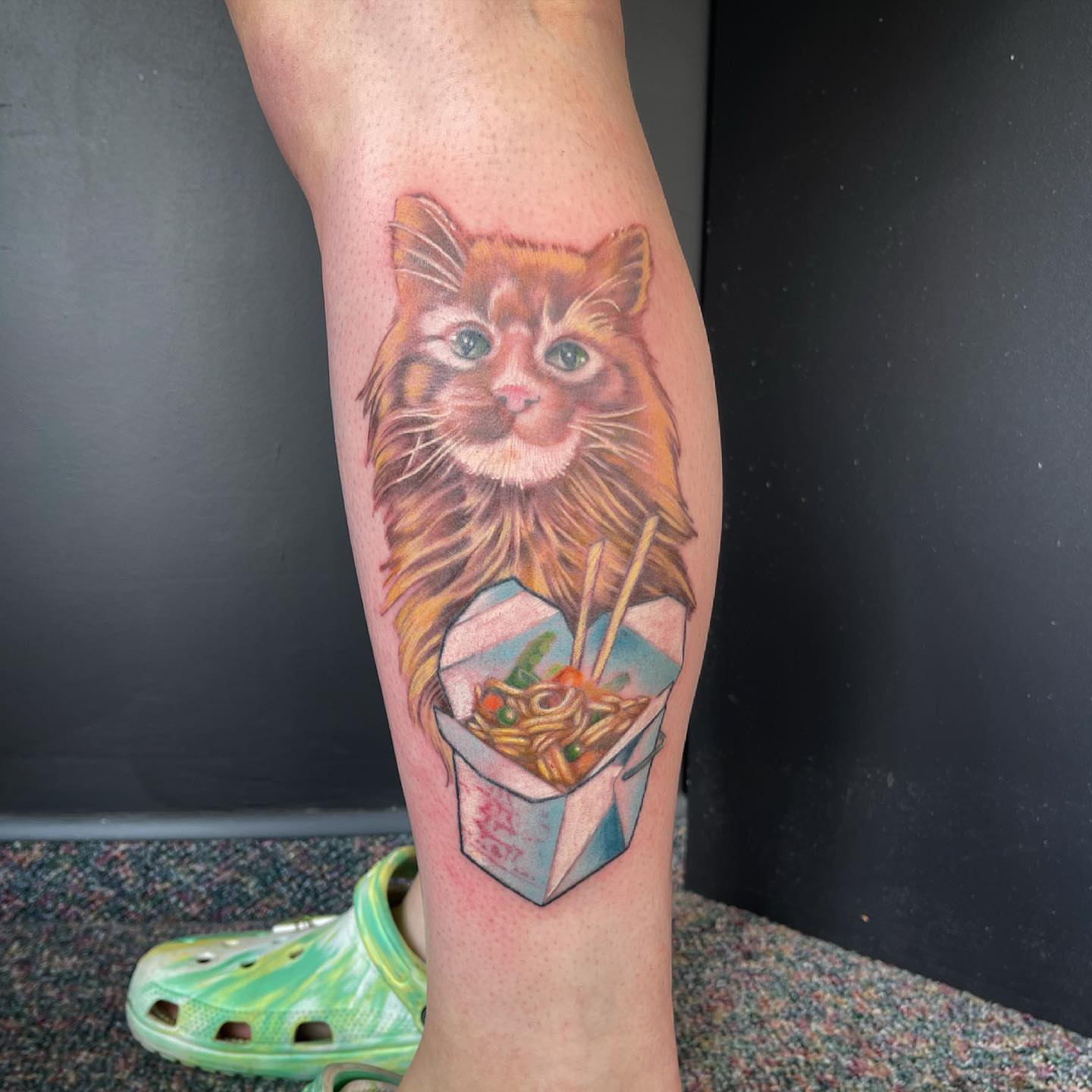Cat and noodles realism tattoo on the calf by Paul Hicks