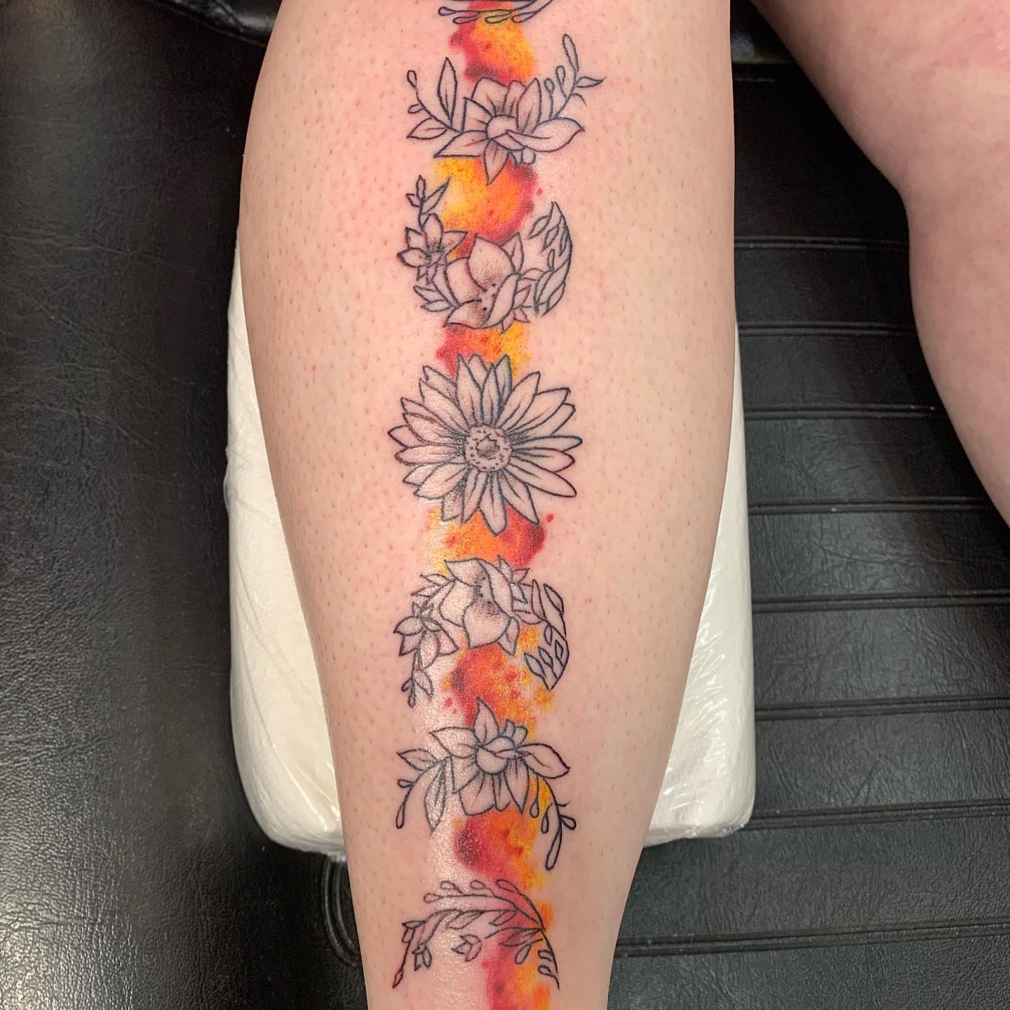 Floral border watercolor tattoo on the calf by IdleHandsFlex, New Orleans, Louisiana