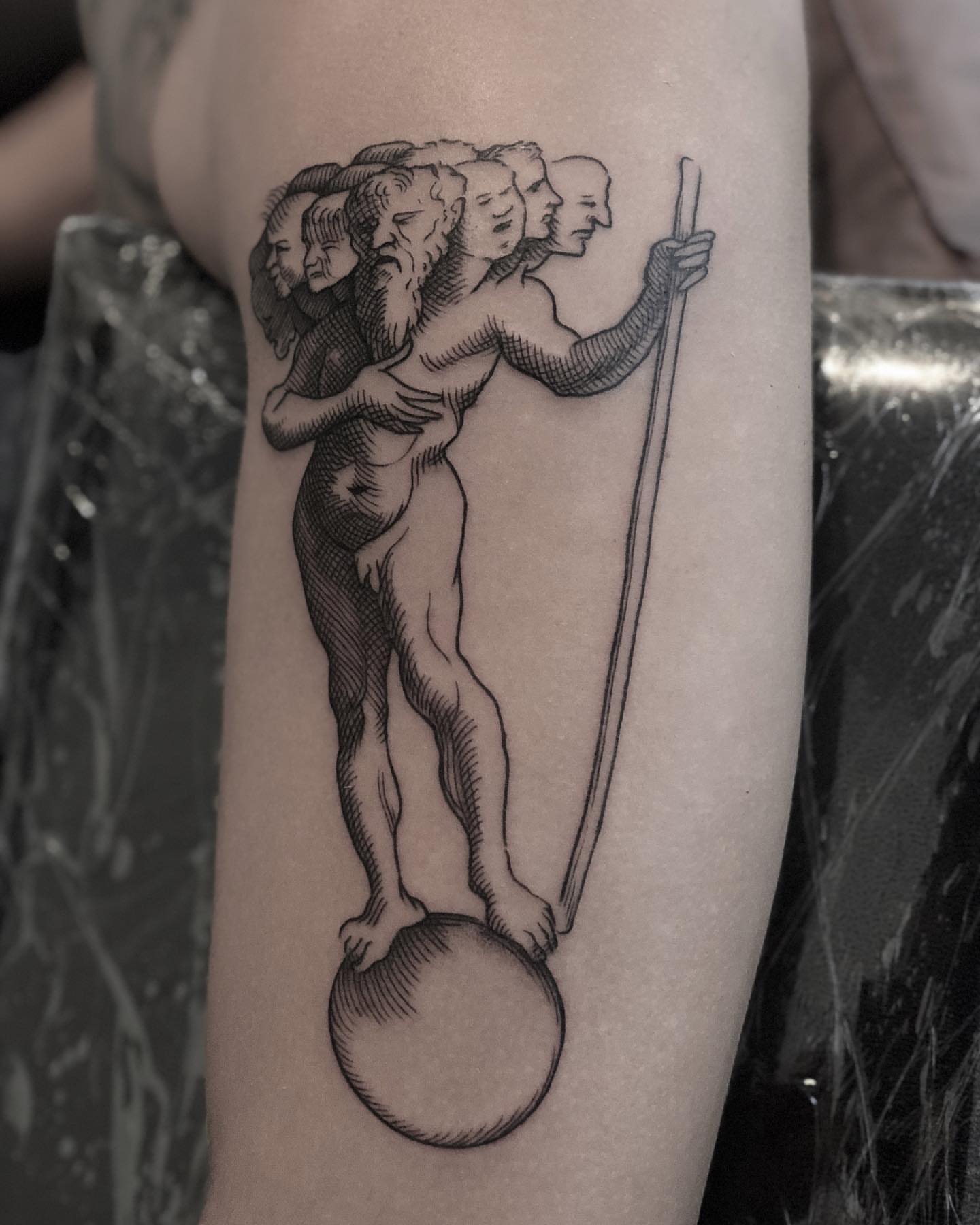 Ancient figure balancing realism tattoo on the forearm by Jorge Nox